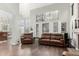 Bright living room featuring hardwood floors, high ceilings, fireplace, and large windows with plantation shutters at 802 N Butte Ave, Chandler, AZ 85226