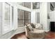 Cozy sitting area with hardwood floors, natural light, and a swivel chair with decorative pillows at 802 N Butte Ave, Chandler, AZ 85226