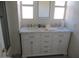 Bathroom with double sink vanity, marble countertops, and modern fixtures at 8219 N 59Th Ave, Glendale, AZ 85302