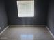 Bedroom with dark gray walls, natural light, and tile flooring at 8219 N 59Th Ave, Glendale, AZ 85302