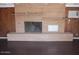 Living room fireplace with brick surround and wood paneling at 8219 N 59Th Ave, Glendale, AZ 85302