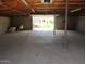 Spacious garage with high ceilings, exposed trusses, and concrete flooring at 8219 N 59Th Ave, Glendale, AZ 85302