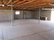 Spacious garage with high ceilings, exposed trusses, and concrete flooring at 8219 N 59Th Ave, Glendale, AZ 85302