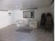 Clean living room with modern chairs, marble floors, and large mirror at 8219 N 59Th Ave, Glendale, AZ 85302
