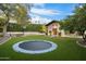 The backyard features a trampoline, a sport court, and lush landscaping at 8306 N Merion Way, Paradise Valley, AZ 85253