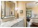 Well-lit bathroom featuring a granite countertop, ample mirror space, and a decorative color palette at 8306 N Merion Way, Paradise Valley, AZ 85253