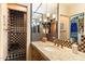 Bathroom featuring granite counters, custom cabinetry, and a walk-in shower with checkered tile at 8306 N Merion Way, Paradise Valley, AZ 85253