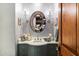 Charming powder room features decorative sconces and a marble vanity at 8306 N Merion Way, Paradise Valley, AZ 85253