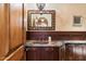 Well-appointed bathroom with wood cabinets, granite countertop, and decorative mirror at 8306 N Merion Way, Paradise Valley, AZ 85253
