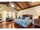 Comfortable bedroom featuring wood floors, a vaulted wood ceiling, accent lighting, and stylish furnishings at 8306 N Merion Way, Paradise Valley, AZ 85253