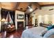 Relaxing bedroom featuring wood floors, a fireplace, a lounge chair, and outdoor views at 8306 N Merion Way, Paradise Valley, AZ 85253
