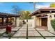 Picturesque courtyard with mature landscaping, stone pavers, and cozy outdoor seating area at 8306 N Merion Way, Paradise Valley, AZ 85253