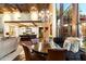 Dining area open to a large kitchen, featuring a round wood table, leather chairs, and a window view at 8306 N Merion Way, Paradise Valley, AZ 85253