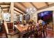 Stylish dining room with a wooden table, ornate chairs, chandelier, exposed wood beam ceiling, and exterior view at 8306 N Merion Way, Paradise Valley, AZ 85253