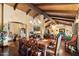 Elegant dining room with a wooden table, ornate chairs, chandelier, exposed wood beam ceiling, and hardwood floors at 8306 N Merion Way, Paradise Valley, AZ 85253