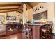 Open-concept floorplan includes a bar and a dining area, with stylish wooden furniture, floors and exposed beam ceiling at 8306 N Merion Way, Paradise Valley, AZ 85253