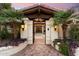 Beautiful private entrance with custom stonework and mature landscaping leading to the double doors at 8306 N Merion Way, Paradise Valley, AZ 85253