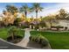 Beautiful single-story home featuring an expansive lawn and a charming paver walkway lined with mature landscaping at 8306 N Merion Way, Paradise Valley, AZ 85253