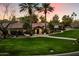 Stunning single story home with lush landscaping and a brick walkway to the front door at 8306 N Merion Way, Paradise Valley, AZ 85253