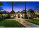 Beautiful single story home with mature trees and manicured lawn leading to a grand entrance at 8306 N Merion Way, Paradise Valley, AZ 85253
