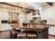 Large kitchen island with seating provides plenty of space for meal prep and entertaining, framed by custom cabinetry at 8306 N Merion Way, Paradise Valley, AZ 85253