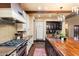 This chef's kitchen is equipped with stainless steel appliances, custom cabinets, and a central island for cooking at 8306 N Merion Way, Paradise Valley, AZ 85253