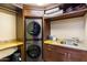 Convenient laundry area features a stacked washer and dryer, counter space, and a sink at 8306 N Merion Way, Paradise Valley, AZ 85253