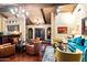 Spacious living room with hardwood floors, beamed ceiling, comfortable seating, and elegant decor at 8306 N Merion Way, Paradise Valley, AZ 85253