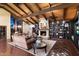 Spacious living room with a fireplace, custom built-ins, wood beam ceiling, and stylish furniture at 8306 N Merion Way, Paradise Valley, AZ 85253
