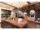 An open-concept layout showcases a large kitchen island flowing into a living room with a fireplace and built-in bookcases at 8306 N Merion Way, Paradise Valley, AZ 85253