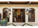 Open entryway view of living area, featuring fireplace and a comfortable seating arrangement at 8306 N Merion Way, Paradise Valley, AZ 85253