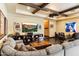 Spacious living room with exposed beam ceiling, comfortable sectional sofa, entertainment center, and stylish decor at 8306 N Merion Way, Paradise Valley, AZ 85253