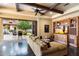Cozy living room with beamed ceiling, comfortable sofa, built-in entertainment center, and seamless indoor-outdoor flow at 8306 N Merion Way, Paradise Valley, AZ 85253