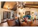 Cozy living room with hardwood floors, fireplace, beamed ceiling, comfortable seating, and elegant decor at 8306 N Merion Way, Paradise Valley, AZ 85253