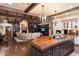 Spacious open-plan living room featuring exposed beams, fireplace, built-in bookcases, and a large kitchen island at 8306 N Merion Way, Paradise Valley, AZ 85253