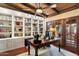Bright office with built-in bookshelves, a large wooden desk, and views to the exterior at 8306 N Merion Way, Paradise Valley, AZ 85253
