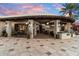 Elegant outdoor entertaining area with a built-in kitchen, bar seating, and access to interior living spaces at 8306 N Merion Way, Paradise Valley, AZ 85253
