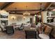Cozy outdoor living space with fireplace, comfortable seating, and stylish decor under a wooden ceiling at 8306 N Merion Way, Paradise Valley, AZ 85253