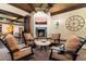 Relaxing outdoor living area with a fireplace, comfortable seating, and a view of the lush backyard at 8306 N Merion Way, Paradise Valley, AZ 85253