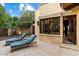 A patio with lounge chairs, access doors and a lush green landscape at 8306 N Merion Way, Paradise Valley, AZ 85253