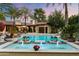 Beautiful outdoor pool with water features, lush plants, and patio furniture create a backyard oasis at 8306 N Merion Way, Paradise Valley, AZ 85253