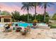 Inviting backyard oasis featuring a sparkling pool, cozy seating, and lush tropical landscaping at 8306 N Merion Way, Paradise Valley, AZ 85253