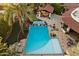 Aerial view of a backyard pool and patio area with an outdoor kitchen and lush landscaping at 8306 N Merion Way, Paradise Valley, AZ 85253