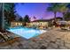 Sprawling pool with outdoor kitchen, swim-up bar, desert landscaping, and lounge chairs for ultimate relaxation at 8306 N Merion Way, Paradise Valley, AZ 85253