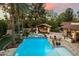 Aerial view of a backyard pool with an outdoor kitchen, lush landscaping, and a cabana at 8306 N Merion Way, Paradise Valley, AZ 85253