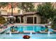 Stunning outdoor pool with fountains, lanterns, palm trees, and lounge chairs create a resort-like feel at 8306 N Merion Way, Paradise Valley, AZ 85253