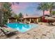 Gorgeous backyard pool area with a cabana, outdoor kitchen, and comfortable lounge seating at 8306 N Merion Way, Paradise Valley, AZ 85253