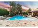 Inviting outdoor pool area with lush landscaping, perfect for relaxing and entertaining at sunset at 8306 N Merion Way, Paradise Valley, AZ 85253