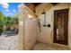 Outdoor shower with mosaic tile, stone privacy wall and lush vegetation at 8306 N Merion Way, Paradise Valley, AZ 85253