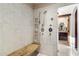 Walk-in shower with a bench and marble-tiled walls and floor at 8306 N Merion Way, Paradise Valley, AZ 85253